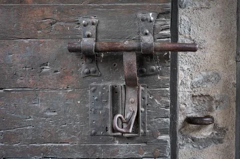Old bolt or latch made in the forge of an old medieval wooden door Fotos de archivo