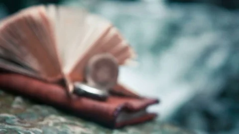 Old book, clock on the background of a waterfall Stock Footage 70962427