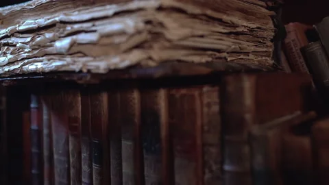 An old book lies on a shelf in an old library Stock-Footage 167586919