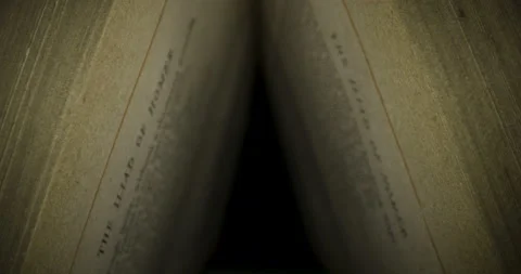 Old book lying with their pages open in 4K against black background, 2 clips Stock Footage 153823043