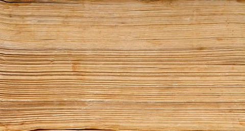 Old book paper background, macro of spine pages folded in stack Stock Photos