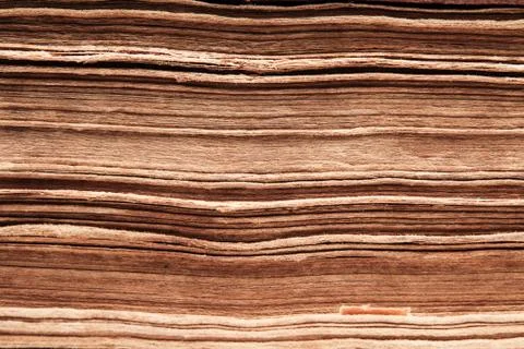 Old book paper background, macro of spine pages folded in stack Stock Photos