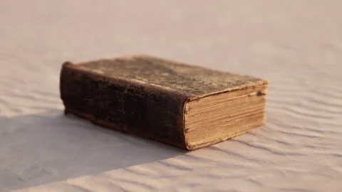 Old book on the sand beach Stock Footage 237880856