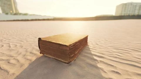 Old book on the sand beach Stock Illustration