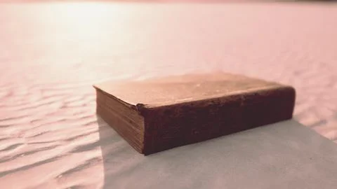 Old book on the sand beach Stock Illustration