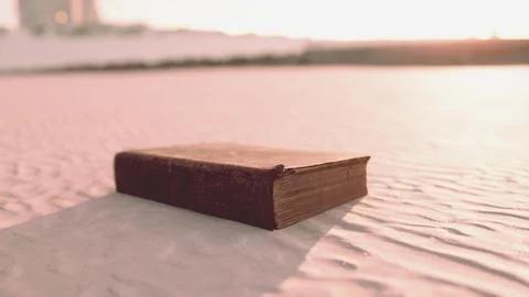 Old book on the sand beach Stock Illustration