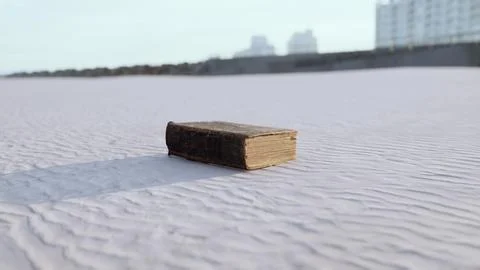 Old book on the sand beach Stock Illustration