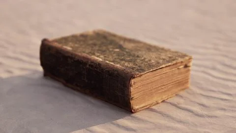 Old book on the sand beach Stock Illustration
