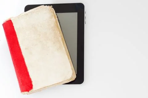 Old book with self-designed tablet computer on white background. Stock Photos