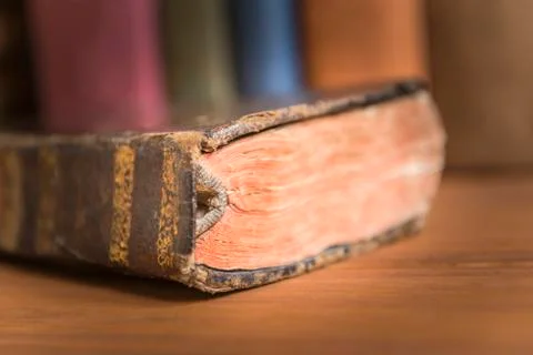 Old book with a stack of books in the background. Stock Photos