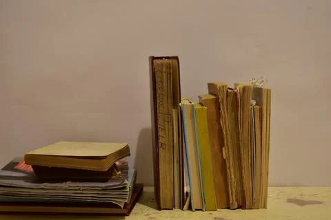 Old book stack on the rustic table Stock Photos