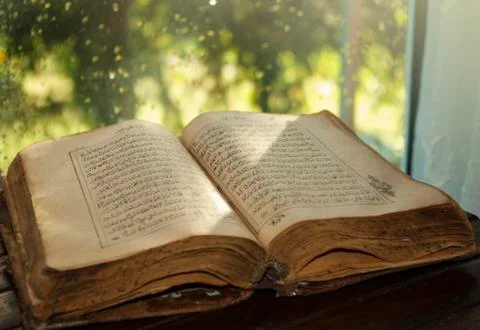 Old book on table Stock Photos