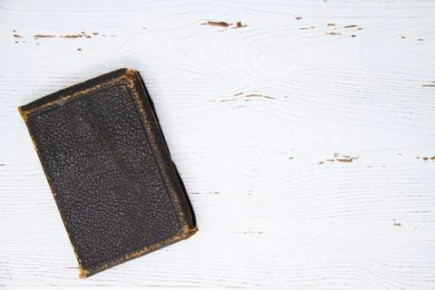 Old book on a white table with copy space Stock Photos