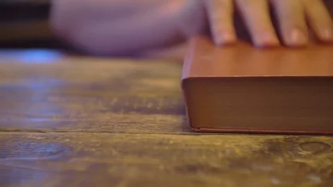Old book on wooden surface.closeup.shallow depth of field 스톡 동영상 102864275
