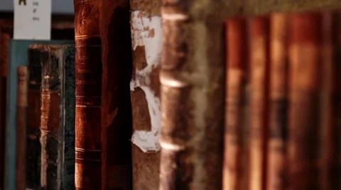 Old books in a bookshelf Stock Footage