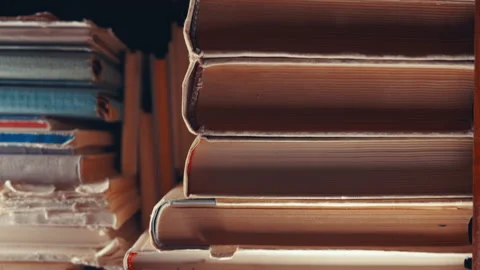 Old Books Stack Close-Up: Different Angle Showing Aged Spines and Worn Pages Stock Footage 339109170
