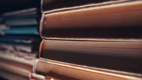 Old Books Stack Close-Up: Vertical Camera Movement Down Aged Book Pages in Books Stock Footage 339105655