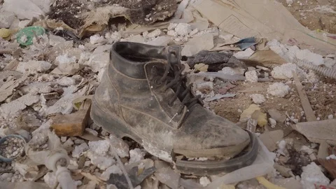 Old boot in the trash Stock Footage 127246504