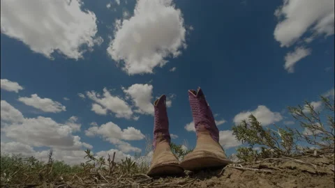Old boots sitting in the wind as clouds travel past, 4K. Stock Footage 139094679