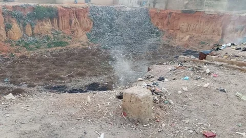 Old Borrow Pit Turned Refuse Dump With Smoke in Local Community Stock Footage 321458508