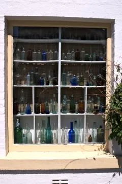 Old bottles in a window Stock Photos