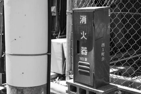 An old box of fire extinguishers on a small street Stock Photos