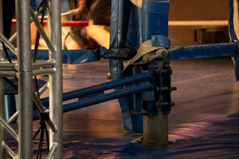 An old boxing ring with a worn corner post and ropes in a gym Stock Photos