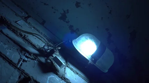 Old branchy lantern burns on a brick wall. Mrag, old basement of house. Stock Footage 122197147