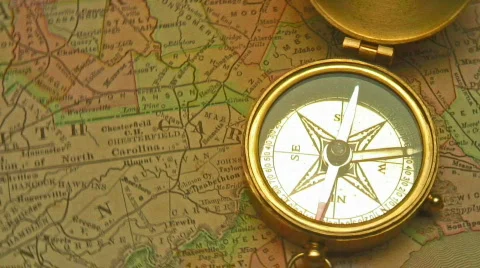 Old brass compass over antique map Stock Footage