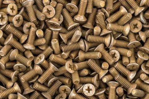 Old brass countersunk phillips head screws. Stock Photos