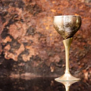 Old brass cup on rusty background Stock Photos