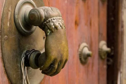 An Old Brass Door Knocker in the Shape of a Hand Stock Photos