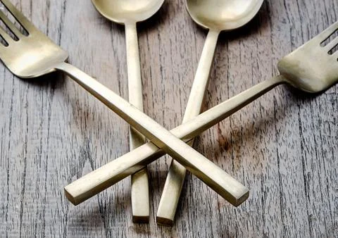 Old brass spoon with fork Stock Photos