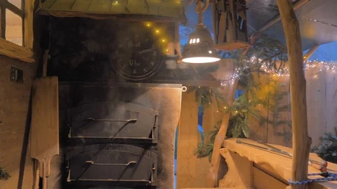 Old bread oven with several doors fuming with Christmas decoration Stock Footage 124495608