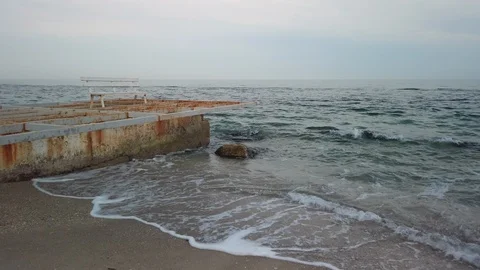 Old breakwater and empty bench - Pan Video stock 108786630