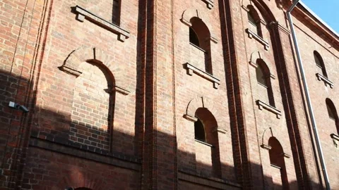 Old brick building with arched windows against a blue sky.   Torun is city .. Stock Footage 235773873