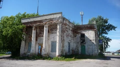 Old brick building of the bus station with columns in the Russian town. Stock Photos