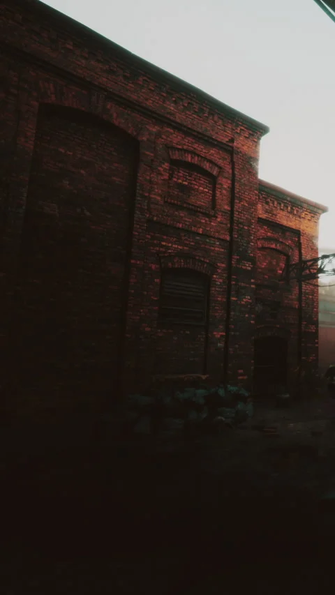 Old brick building with dark shadows and faint light in the background Stock-Footage 343155232