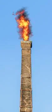 Old brick chimney on fire Foto stock