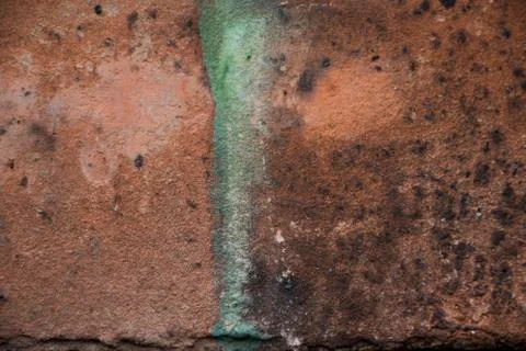 Old brick close up. Orange brick close up with paint stain.  Stock Photos