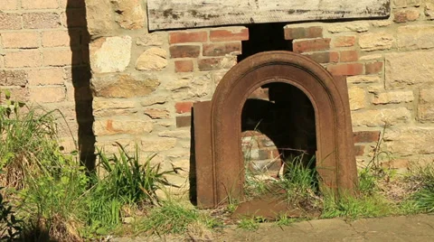 Old brick fireplace with grass and weeds growing Stock Footage 37632443