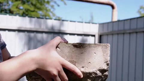 Old brick in hands against the sky Stock Footage 293202636