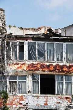 Old brick house. Window frames without glass. Stock Photos