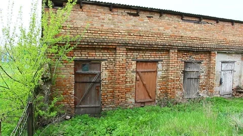 Old brick outbuildings of the soviet union in the Kirovograd region Stock Footage 153397093