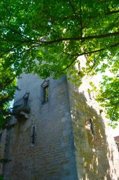 An old brick tower surrounded by trees. Stock Photos