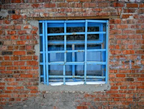 Old brick wall and window with bars Stock Photos