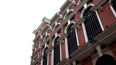 Old brick wall background building with vintage windows on bright cloudy sky Stock-Footage 128250291