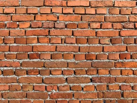 Old brick wall background with cracked and broken bricks Stock Photos