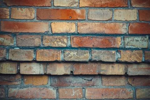 Old brick wall background with different bricks Fotos Stock