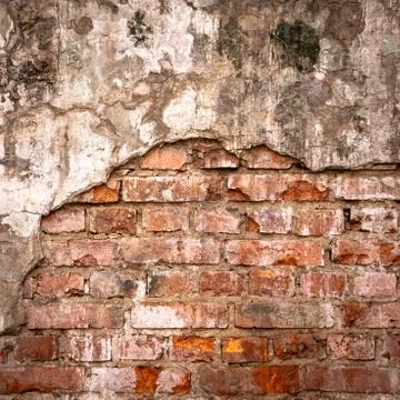 Old brick wall in a background image. Plastered Brickwall With Chipped Stucco Stock Photos